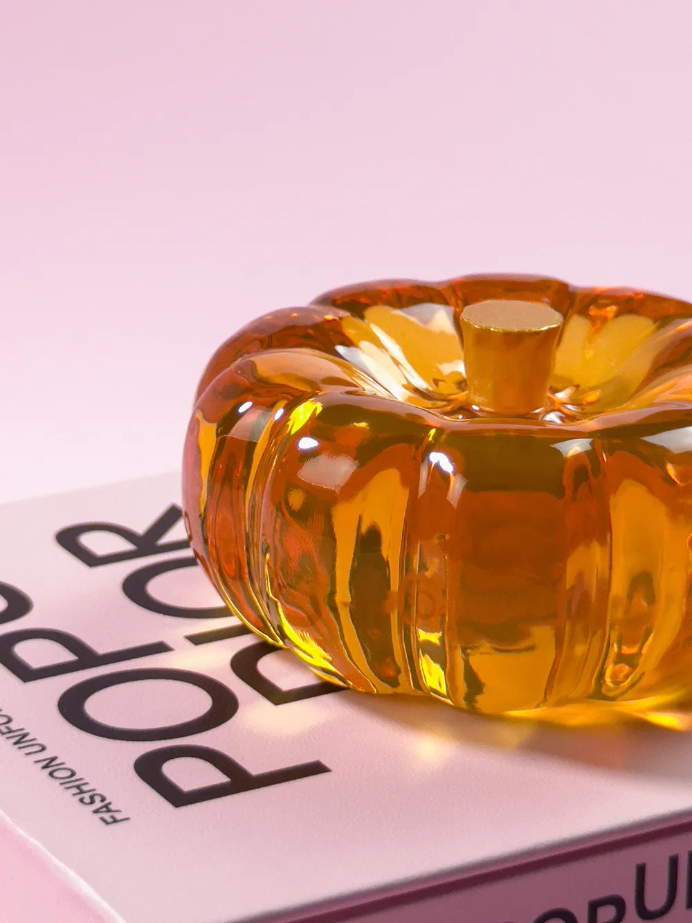 Amber orange resin specimen art object by momu. Handcrafted archival fragment with a warm, glowing amber tone.