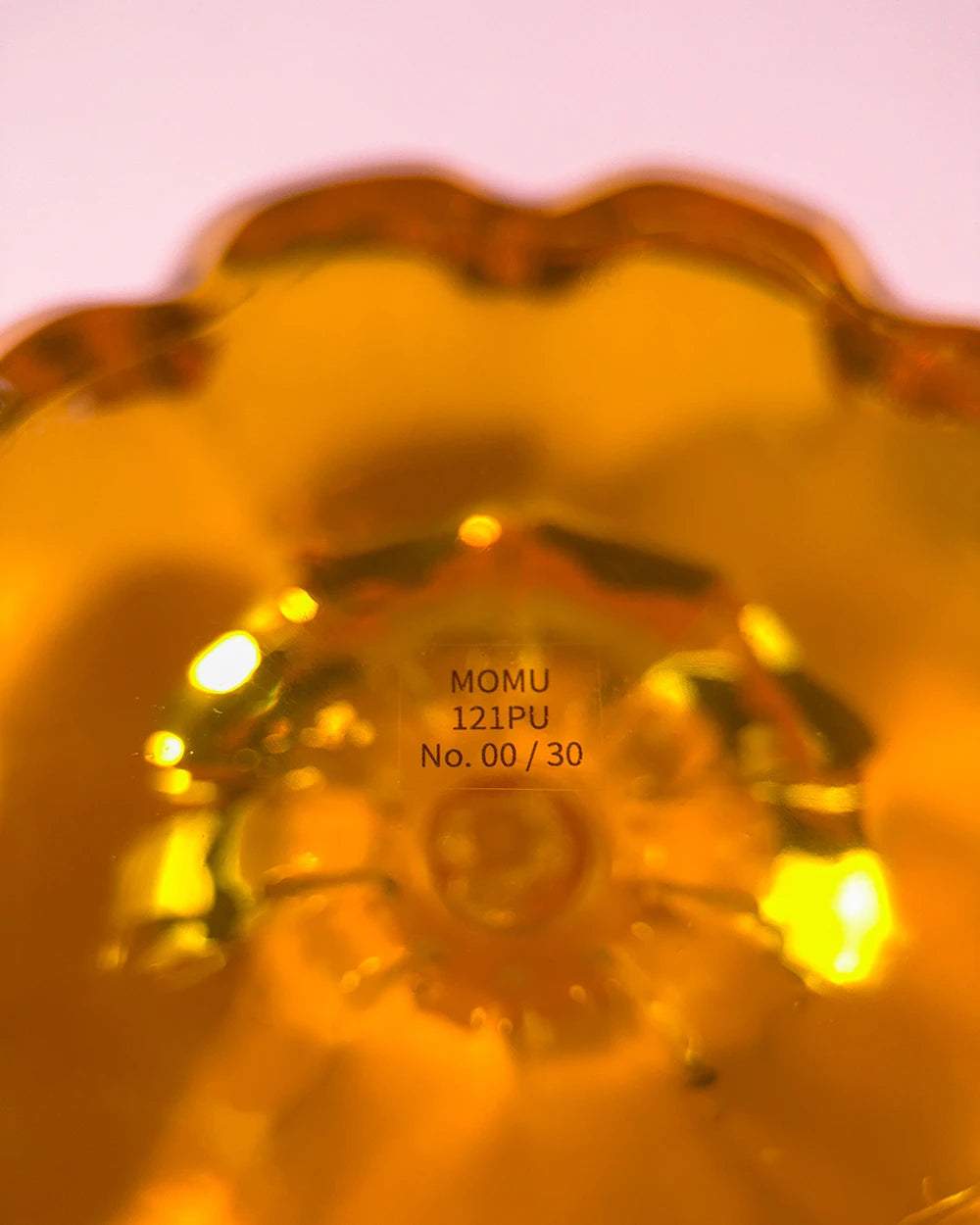 Amber orange resin specimen art object by momu. Handcrafted archival fragment with a warm, glowing amber tone.