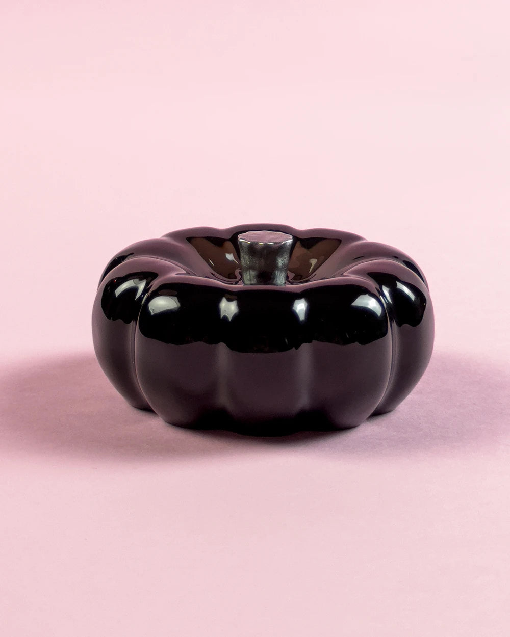 Glossy black resin specimen by momu. Mysterious dark archival fragment with a sleek, reflective finish.