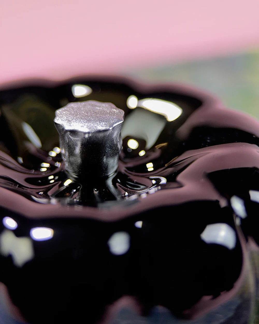 Glossy black resin specimen by momu. Mysterious dark archival fragment with a sleek, reflective finish.