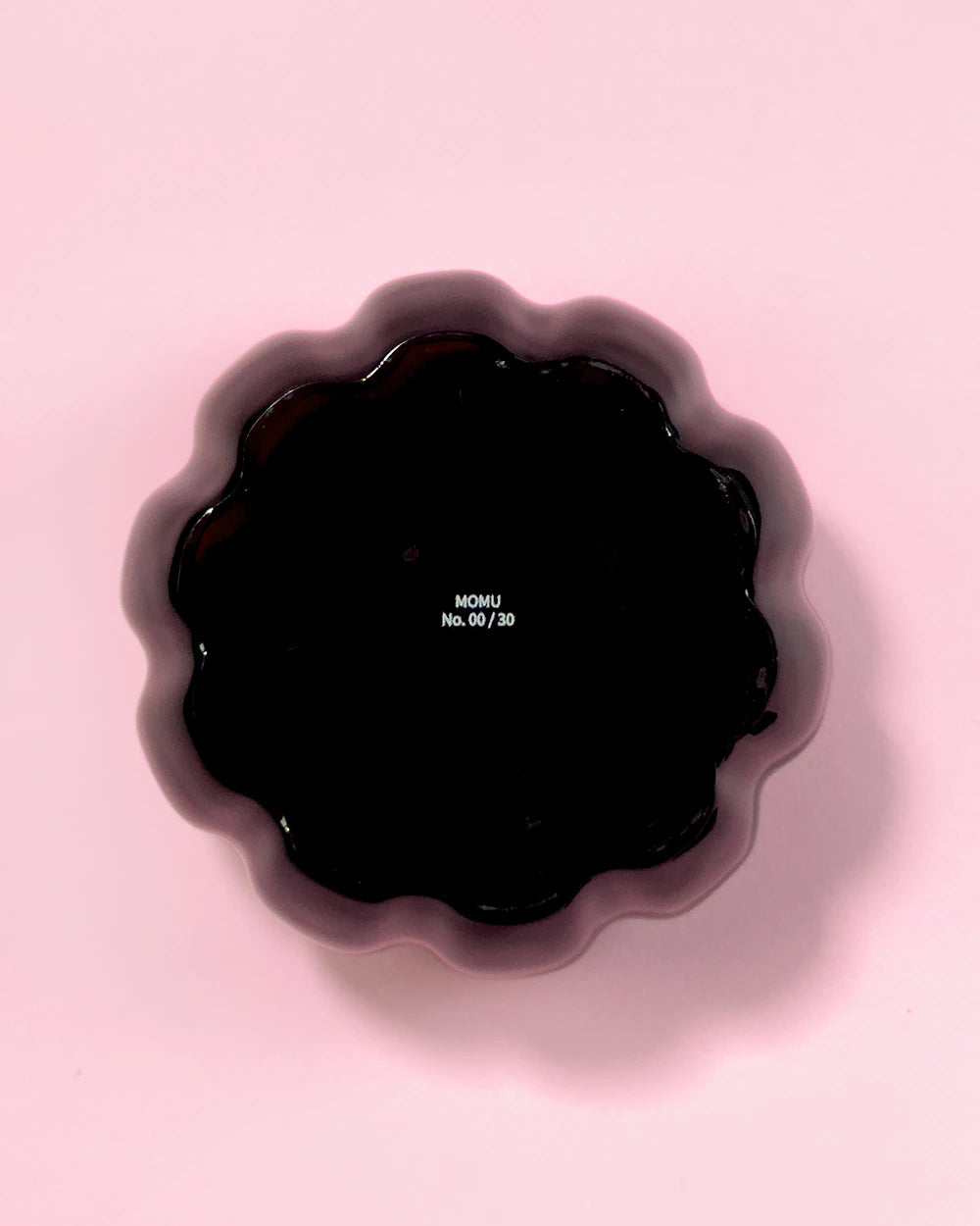 Glossy black resin specimen by momu. Mysterious dark archival fragment with a sleek, reflective finish.