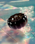Glossy black resin specimen by momu. Mysterious dark archival fragment with a sleek, reflective finish.